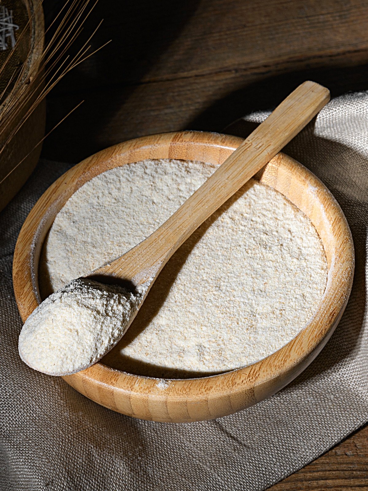A wooden bowl and spoon with Kamut Flour.