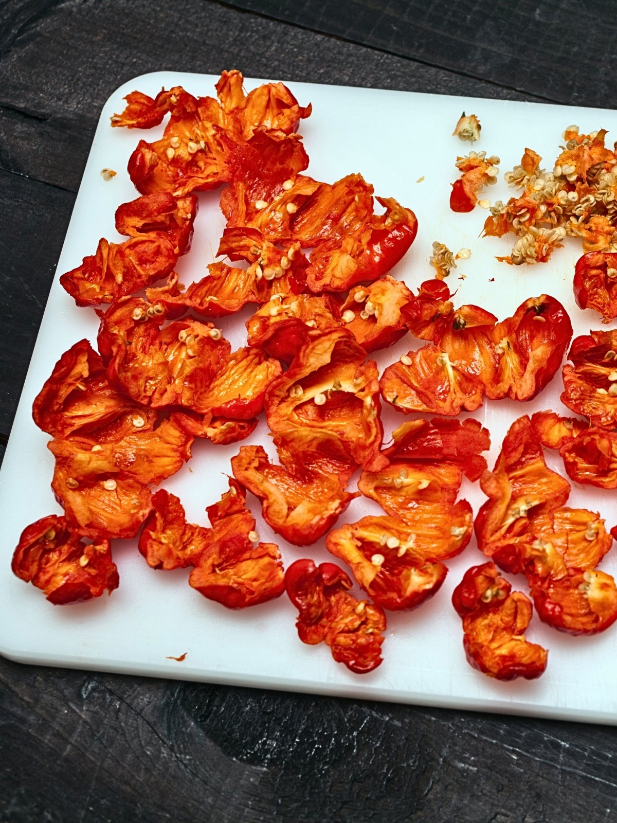 Deseeded Trinidad Moruga Scorpion peppers on a white chopping board.